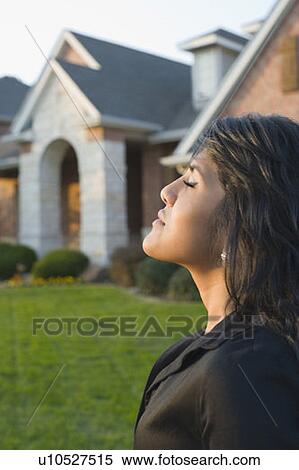 Stock Photography - Close-up of a young woman thinking. Fotosearch