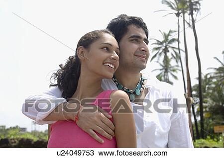 Close-up of a young couple smiling View Large Photo Image Stock Image - Close-up of a young couple smiling. Fotosearch
