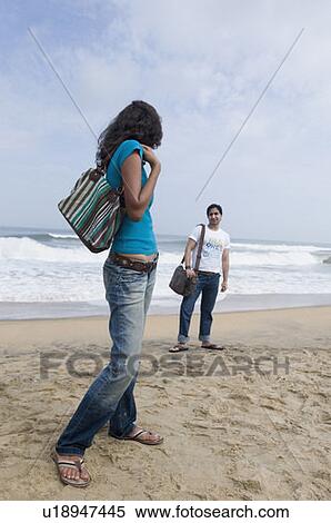 Young couple standing on the beach View Large Photo Image Stock Photography - Young couple standing on the beach. Fotosearch