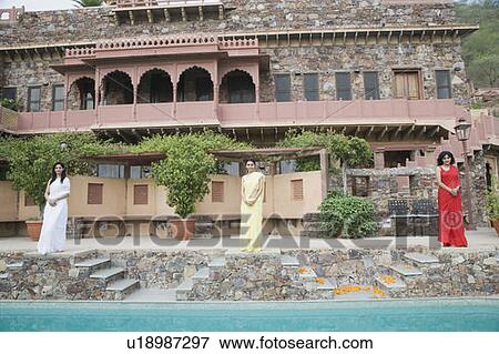 Three young women standing at the poolside of a palace, Neemrana Fort Palace, Neemrana, Alwar, Rajasthan, India View Large Photo Image Stock Photo - Three young women standing at the poolside of a palace, Neemrana Fort Palace, Neemrana, Alwar, Rajasthan, India. Fotosearch