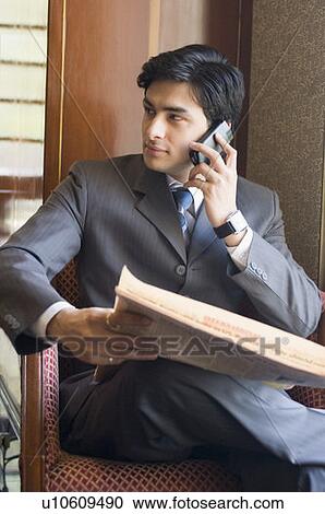 Stock Image - Businessman talking on a mobile phone. Fotosearch