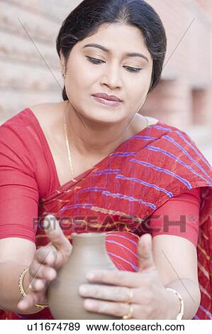 Stock Photo - Close-up of a mid adult woman making a pottery. Fotosearch