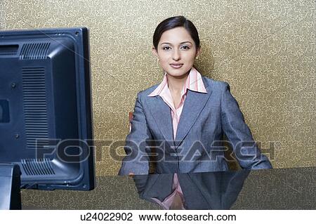 Portrait of a female receptionist sitting at a hotel reception View Large Photo Image Stock Image - Portrait of a female receptionist sitting at a hotel reception. Fotosearch