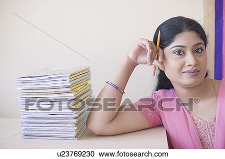 Portrait of a mid adult woman leaning against a desk View Large Photo Image Stock Image - Portrait of a mid adult woman leaning against a desk. Fotosearch