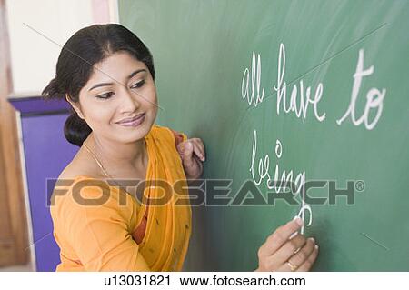 School teacher teaching in a classroom View Large Photo Image Stock Image - School teacher teaching in a classroom. Fotosearch