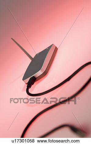 Stock Photo - Close-up of a computer cable connected to a wireless router. Fotosearch