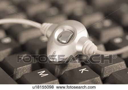 Stock Photo - Close-up of a microphone on a computer keyboard. Fotosearch