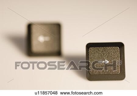 Stock Photo - Close-up of an arrow sign on two computer keys. Fotosearch