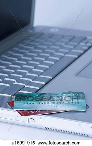 Close-up of two credit cards on a laptop View Large Photo Image Stock Photography - Close-up of two credit cards on a laptop. Fotosearch