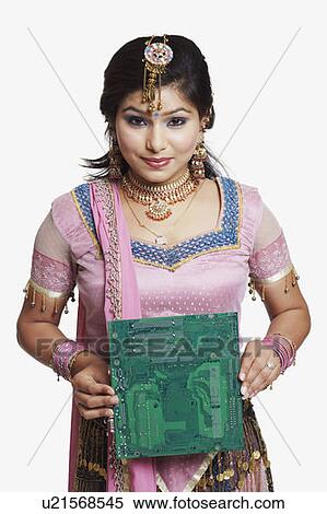 Stock Photography - Portrait of a young woman holding a circuit board. Fotosearch