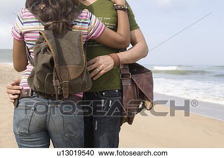 Mid section view of a couple embracing each other on the beach View Large Photo Image Stock Image - Mid section view of a couple embracing each other on the beach. Fotosearch