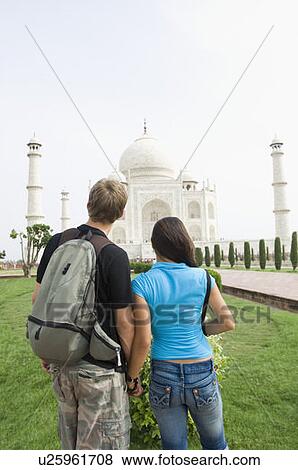 Rear view of a young couple looking at a mausoleum, Taj Mahal, Agra, Uttar Pradesh, India View Large Photo Image Stock Photo - Rear view of a young couple looking at a mausoleum, Taj Mahal, Agra, Uttar Pradesh, India. Fotosearch