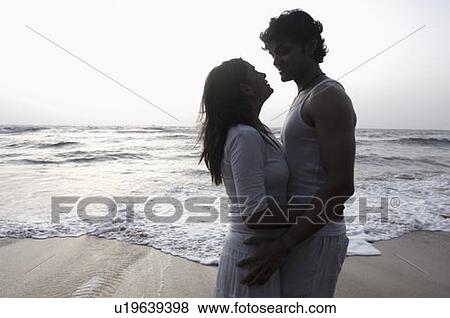 Silhouette of a young couple embracing each other on the beach, Goa, India View Large Photo Image Stock Photo - Silhouette of a young couple embracing each other on the beach, Goa, India. Fotosearch