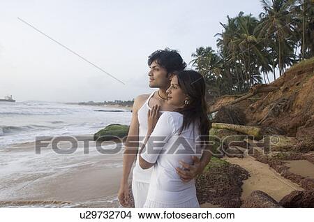 Young couple romancing on the beach, Goa, India View Large Photo Image Picture - Young couple romancing on the beach, Goa, India. Fotosearch