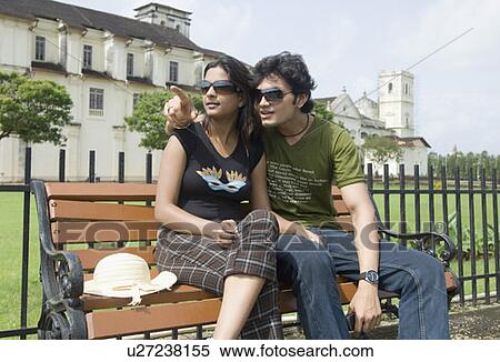 Young couple sitting on a bench and a cathedral in the background, Se Cathedral, Goa, India View Large Photo Image Stock Photography - Young couple sitting on a bench and a cathedral in the background, Se Cathedral, Goa, India. Fotosearch