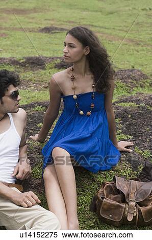 Young couple sitting on a rock View Large Photo Image Stock Photography - Young couple sitting on a rock. Fotosearch