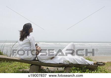 Young man lying on the lap of a young woman View Large Photo Image Stock Photo - Young man lying on the lap of a young woman. Fotosearch