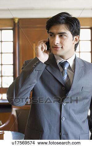 Picture - Close-up of a businessman talking on a mobile phone. Fotosearch