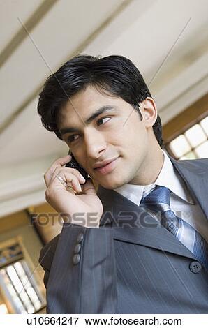 Close-up of a businessman talking on a mobile phone View Large Photo Image Stock Photo - Close-up of a businessman talking on a mobile phone. Fotosearch