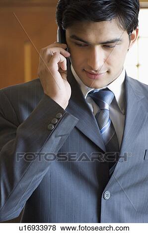 Stock Photo - Close-up of a businessman talking on a mobile phone. Fotosearch