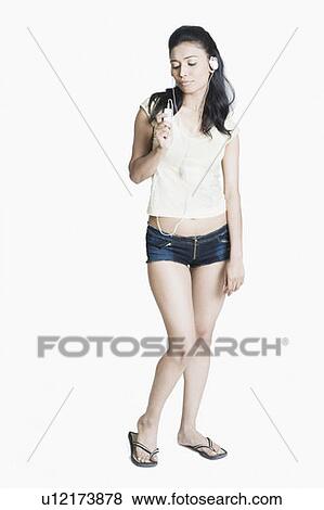 Young woman listening to an MP3 player View Large Photo Image Stock Photo - Young woman listening to an MP3 player. Fotosearch