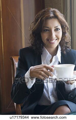 Close-up of a businesswoman holding a cup of tea View Large Photo Image Picture - Close-up of a businesswoman holding a cup of tea. Fotosearch