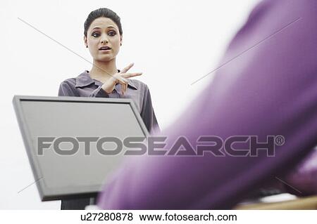 Stock Photo - Discussion between two businesswomen. Fotosearch