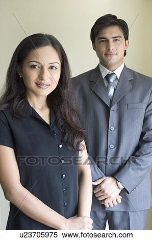 Stock Photography - Portrait of a businesswoman and a businessman smiling. Fotosearch