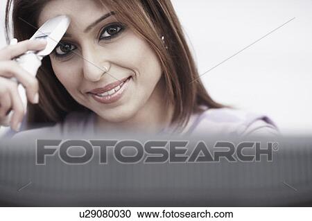 Portrait of a businesswoman holding a mobile phone View Large Photo Image Stock Image - Portrait of a businesswoman holding a mobile phone. Fotosearch