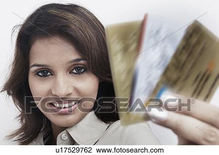 Portrait of a businesswoman holding credit cards View Large Photo Image Stock Image - Portrait of a businesswoman holding credit cards. Fotosearch