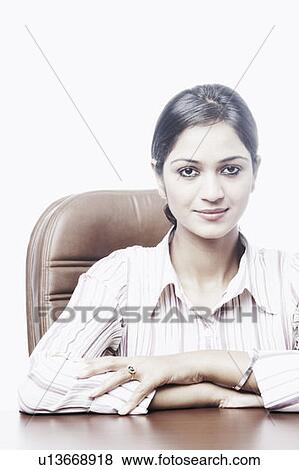 Portrait of a businesswoman sitting on a chair View Large Photo Image Stock Photo - Portrait of a businesswoman sitting on a chair. Fotosearch