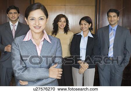 Portrait of a businesswoman standing with her colleagues View Large Photo Image Stock Image - Portrait of a businesswoman standing with her colleagues. Fotosearch