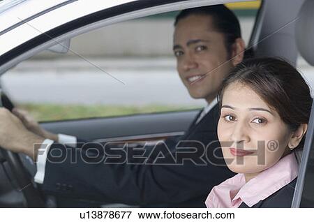 Stock Photo - Portrait of a businesswoman with a businessman smiling in the background, Singapore. Fotosearch