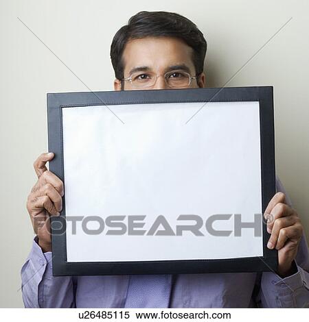 Portrait of a businessman holding a blank picture frame View Large Photo Image Stock Photography - Portrait of a businessman holding a blank picture frame. Fotosearch