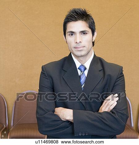 Portrait of a businessman standing with his arms crossed View Large Photo Image Stock Photo - Portrait of a businessman standing with his arms crossed. Fotosearch
