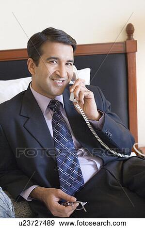Portrait of a businessman talking on the telephone and smiling View Large Photo Image Stock Photo - Portrait of a businessman talking on the telephone and smiling. Fotosearch