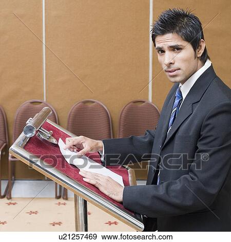 Stock Photo - Side profile of a businessman giving a speech. Fotosearch