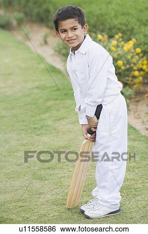 Stock Photograph - Boy holding a cricket bat. Fotosearch