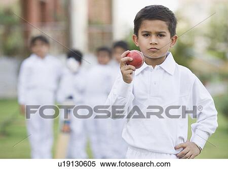 Stock Photography - Cricketer holding a cricket ball. Fotosearch