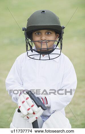 Cricketer standing in a cricket field View Large Photo Image Picture - Cricketer standing in a cricket field. Fotosearch