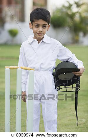 Portrait of a boy holding a sports helmet and smiling View Large Photo Image Picture - Portrait of a boy holding a sports helmet and smiling. Fotosearch