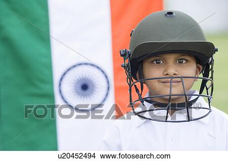Portrait of a cricket player smiling with an Indian flag in the background View Large Photo Image Picture - Portrait of a cricket player smiling with an Indian flag in the background. Fotosearch