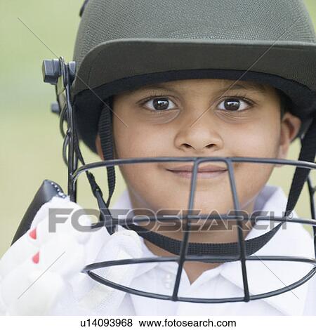 Stock Photo - Portrait of a cricket player smiling. Fotosearch