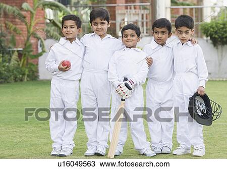 Stock Image - Portrait of five boys standing in a lawn. Fotosearch