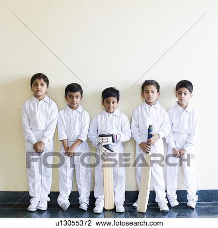 Stock Image - Portrait of five boys standing in a row. Fotosearch