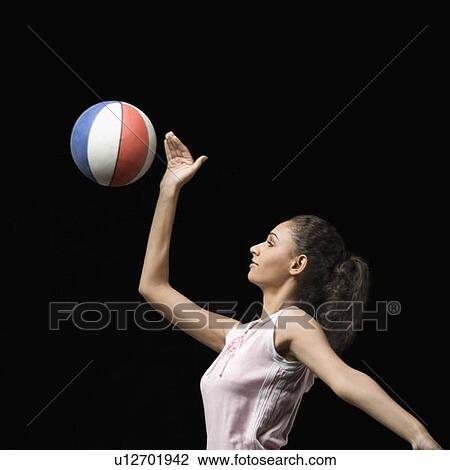 Side profile of a young woman playing volleyball View Large Photo Image Stock Image - Side profile of a young woman playing volleyball. Fotosearch