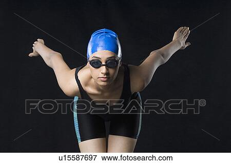 Young woman standing in a position to dive View Large Photo Image Stock Photo - Young woman standing in a position to dive. Fotosearch