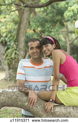 Stock Image - Portrait of a young couple smiling. Fotosearch