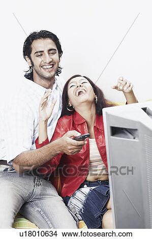 Young couple watching television View Large Photo Image Picture - Young couple watching television. Fotosearch