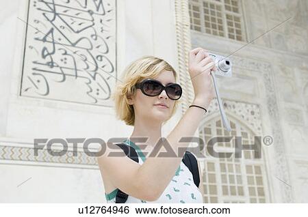 Close-up of a young woman photographing in front of a mausoleum, Taj Mahal, Agra, Uttar Pradesh, India View Large Photo Image Stock Photograph - Close-up of a young woman photographing in front of a mausoleum, Taj Mahal, Agra, Uttar Pradesh, India. Fotosearch
